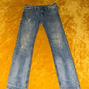 Boys diesel jeans with decorative tears and rips and a light blue wash size 10 y